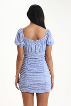 Load image into Gallery viewer, Short bubble sleeve, a sweetheart tied neckline and ruching throughout, makes this mini dress your perfect summer go-to. With a dainty floral print, invite its color, cloud blue into your wardrobes.