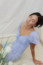 Load image into Gallery viewer, Short bubble sleeve, a sweetheart tied neckline and ruching throughout, makes this mini dress your perfect summer go-to. With a dainty floral print, invite its color, cloud blue into your wardrobes.