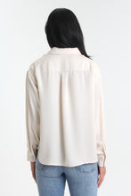 Load image into Gallery viewer, With a silky sheen to this creme colored classic, introduce this staple to your closet. Featuring button-down detailing, button cuffed sleeves and timeless collar, the look is elevated with its boyfriend fit.