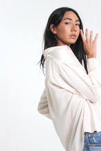 Load image into Gallery viewer, With a silky sheen to this creme colored classic, introduce this staple to your closet. Featuring button-down detailing, button cuffed sleeves and timeless collar, the look is elevated with its boyfriend fit.