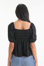 Load image into Gallery viewer, Made with a textured woven stripe, this sweetheart neckline blouse features short bubble sleeves, a tied front and smocked back detailing. With its babydoll silhouette, easily consider this a go-to piece in your wardrobe.