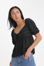 Load image into Gallery viewer, Made with a textured woven stripe, this sweetheart neckline blouse features short bubble sleeves, a tied front and smocked back detailing. With its babydoll silhouette, easily consider this a go-to piece in your wardrobe.