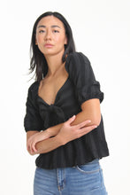 Load image into Gallery viewer, Made with a textured woven stripe, this sweetheart neckline blouse features short bubble sleeves, a tied front and smocked back detailing. With its babydoll silhouette, easily consider this a go-to piece in your wardrobe.