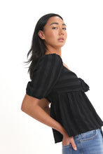 Load image into Gallery viewer, Made with a textured woven stripe, this sweetheart neckline blouse features short bubble sleeves, a tied front and smocked back detailing. With its babydoll silhouette, easily consider this a go-to piece in your wardrobe.