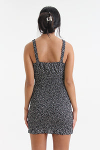 Show your best assets in this abstract dot printed, body con mini dress. Featuring ruffled straps, a tied sweetheart neckline and smocking throughout, find yourself looking for this dress on those sweet yet sexy occasions life may bring.