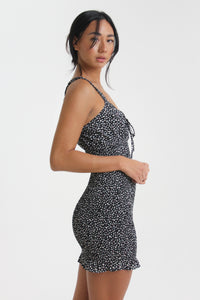 Show your best assets in this abstract dot printed, body con mini dress. Featuring ruffled straps, a tied sweetheart neckline and smocking throughout, find yourself looking for this dress on those sweet yet sexy occasions life may bring.