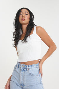 Slightly cropped for those high-waisted bottoms, this ivory colored, ribbed tank will help you achieve any effortless look. Featuring thick straps and a sweetheart neckline, easily use this staple for a dressed up or down look.