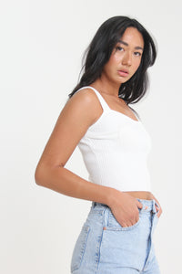 Slightly cropped for those high-waisted bottoms, this ivory colored, ribbed tank will help you achieve any effortless look. Featuring thick straps and a sweetheart neckline, easily use this staple for a dressed up or down look.