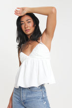 Load image into Gallery viewer, Our babydoll, adjustable spaghetti strapped, tie bow back blouse is made out of a textured woven. With its sweet silhouette, consider this a summer staple paired with a classic heel or casual sneaker.
