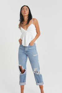 Our babydoll, adjustable spaghetti strapped, tie bow back blouse is made out of a textured woven. With its sweet silhouette, consider this a summer staple paired with a classic heel or casual sneaker.